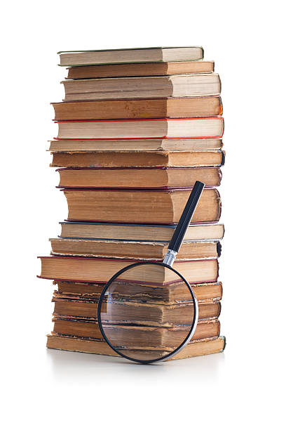 istock Magnifying glass and old books 174917714