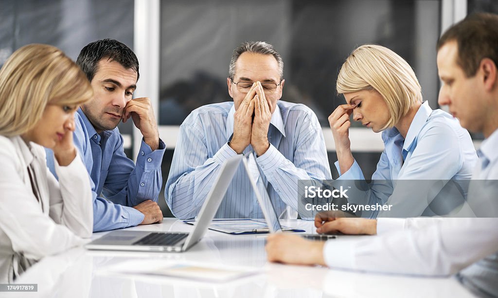 Businesspeople expressing stress at work Five stressful businesspeople having problems at work. Business Person Stock Photo