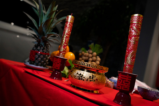 Joss sticks and candle during a praying Chinese wedding ceremony