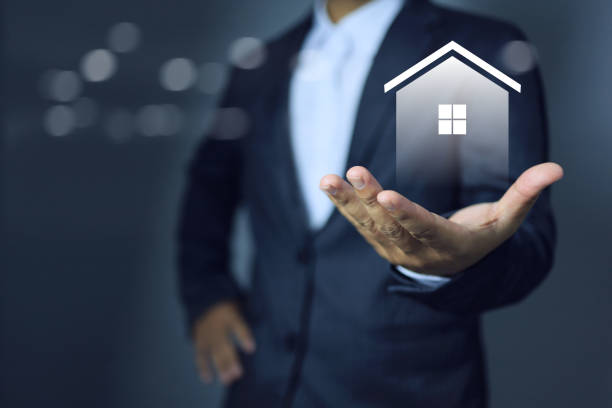 istock Businessman holding home 1749184684