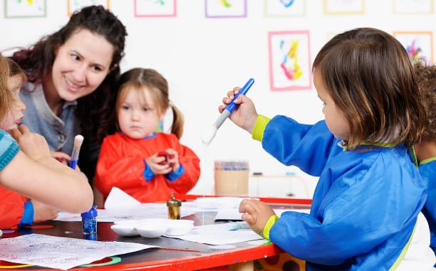 istock Group Of Little Children Using Glue To Create Art 174918591