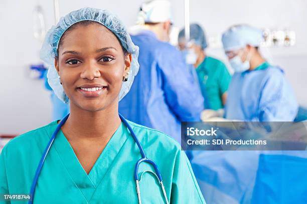 Confident Surgical Nurse Surgery Being Performed In Hospital Stock Photo - Download Image Now