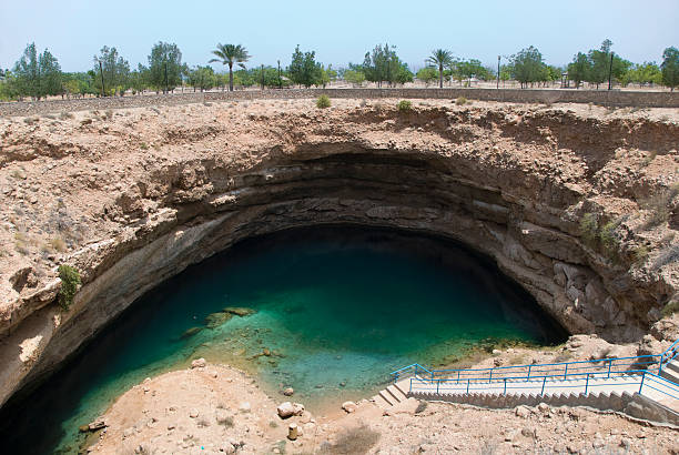 hawiyat najm 公園 - sinkhole sinkhole hawiyat najm park cliff ストックフォトと画像