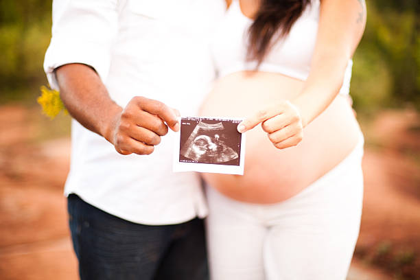 istock Future parents holding ultrasound picture 174919094