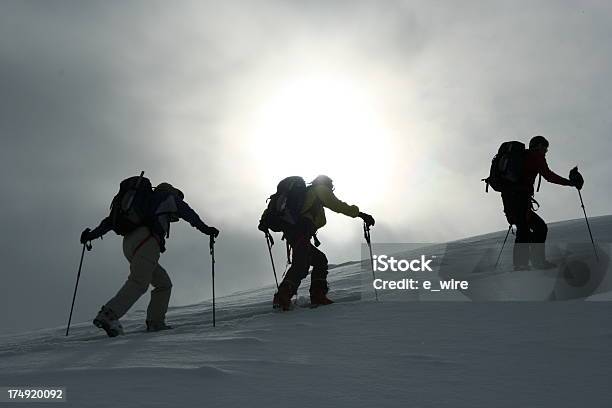 Silhouettes Of Three Crosscountry Skiers Climbing A Ridge Stock Photo - Download Image Now