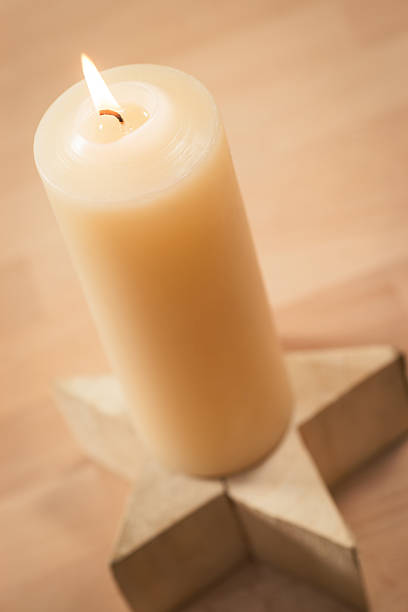 istock Christmas candle on wooden star angled view 174920120