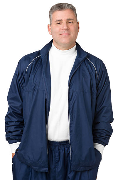 Portrait Of Mature Man In Track Suit Portrait of a mature man isolated on a white background.  crew cut stock pictures, royalty-free photos & images