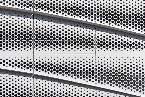 Dots background on the wall surface of a modern parking lot.