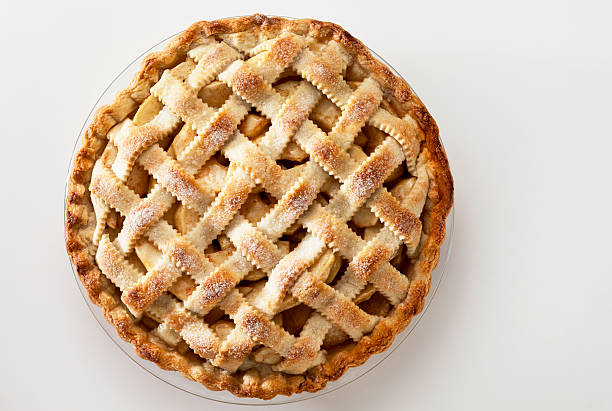 Apple Pie A lattice top apple pie on a light background. sweet pie stock pictures, royalty-free photos & images
