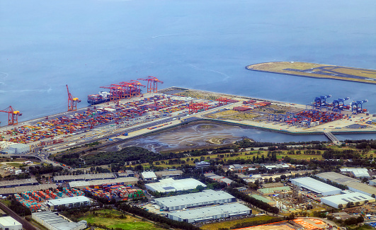 Botany bay airport and cargo shipment transport terminal in Sydney city - aerial view.