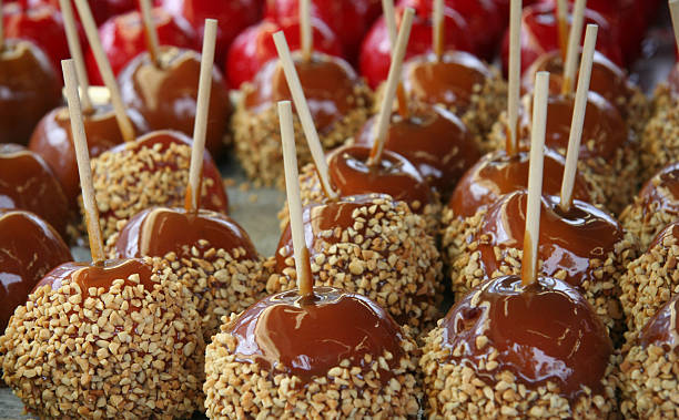 Group Of Caramel Apples Covered With Nut Pieces