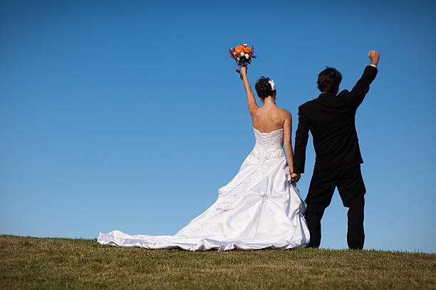 istock Bride and Groom Raising Their Hands in Celebration 174921524