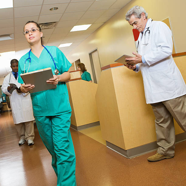 istock Hospital staff at busy nurses station 174921528