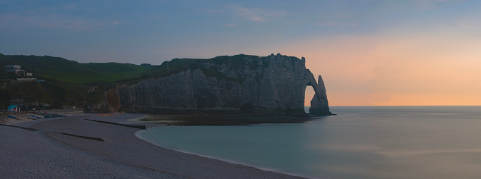 This natural flint arch rises from the Atlantic coast near the seaside town of Etretat in the Normandy department of northwestern France.  The arch sits at the end of the renowned white limestone cliffs of Etretat.