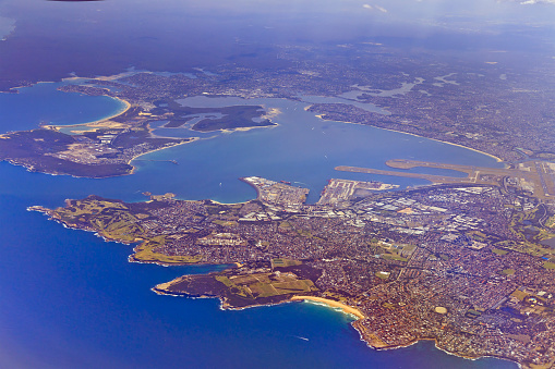 Transport hub of Port Botany and Sydney International airport in Sydney around Botany bay - aerial altitude view of the coast.