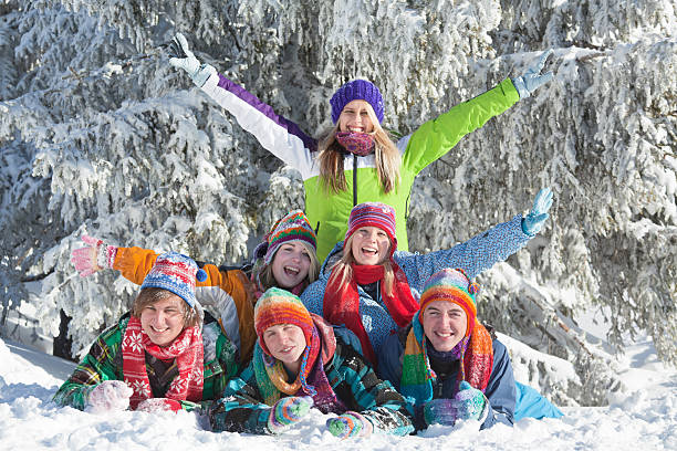 istock Group of happy young people lying in snow 174922000