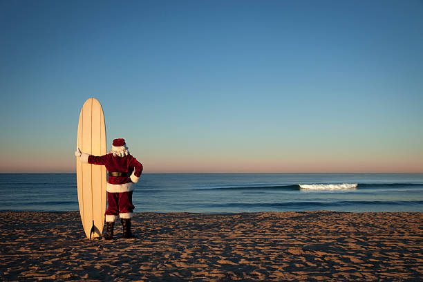 Santa on Vacation This is a conceptual photo relating to taking a Christmas vacation.Click on the links below to view lightboxes. longboard skating photos stock pictures, royalty-free photos & images