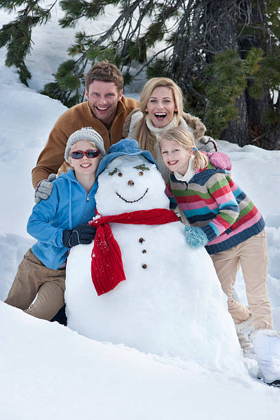 istock Happy Family with Snowman 174922546