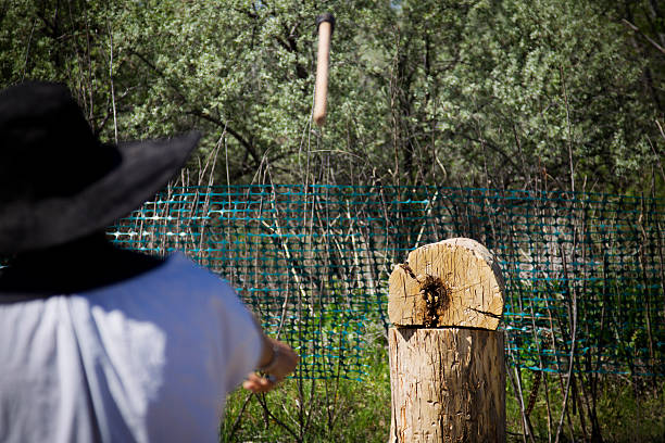 Axe Throwing A man throwing an axe, axe in blurred motion. axe throwing stock pictures, royalty-free photos & images