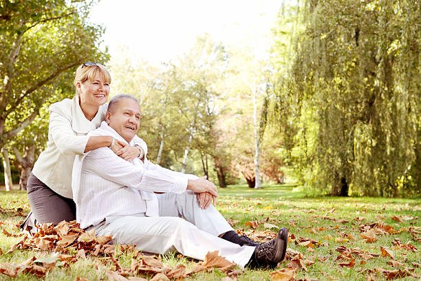 istock Mature couple relaxing in a park 174925559