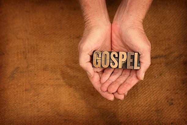 istock Printing press letters spell out Gospel in cupped hands 174925861