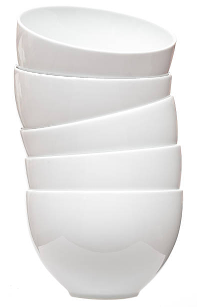 Casual stack of five white ceramic bowls stock photo