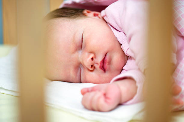 istock Newborn baby sleeping in crib 174926684