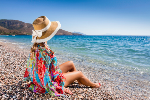 Woman seated at a paceful beach