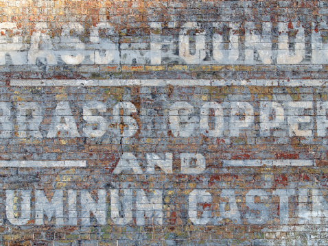 Decaying old sign on an old brick wall. Amazing texture and detail.
