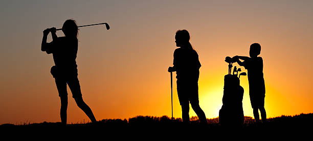 istock Junior Girls Golfing Silhouette with Young Caddie 174927698