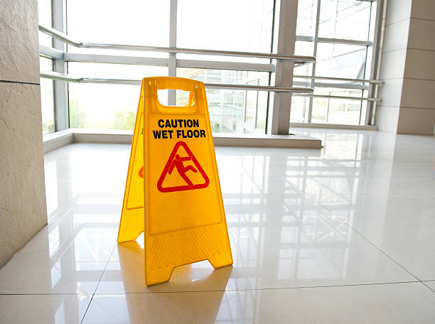 istock A yellow wet floor warning sign on an office floor 174927850