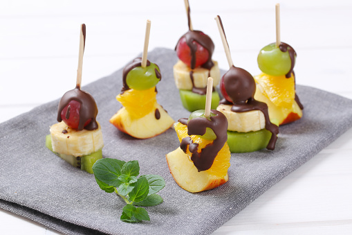 fruit canapes (mini fruit skewers) with chocolate drizzle