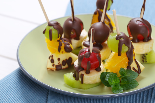 fruit canapes (mini fruit skewers) with chocolate drizzle