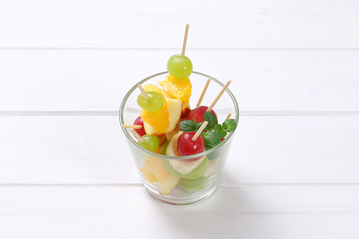fresh fruit canapes (mini fruit kabobs) in glass cup