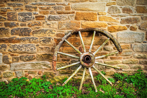 荷馬車の車輪と石の壁 - wooden hub ストックフォトと画像