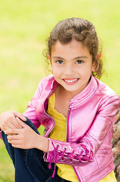 Little Smiling Girl Looking into Camera stock photo