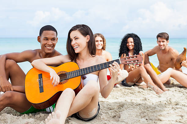 ご友人がビーチでの音楽 - multi ethnic group beach women maraca ストックフォトと画像