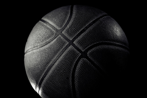 Leather basketball on black background