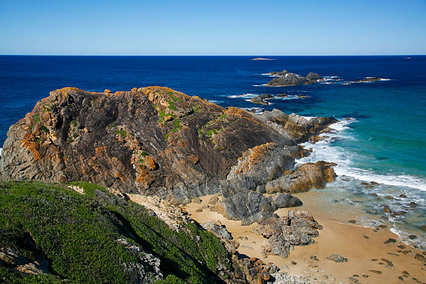 istock Rocky headland juts into calm blue ocean 174929539