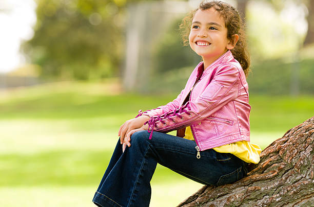 Full Profile Shot of Little Girl in Park stock photo
