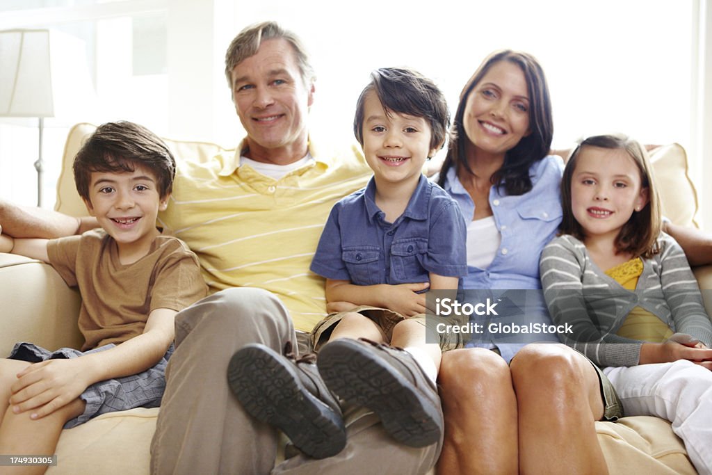 Portrait of a loving family Portrait of a happy family of five sitting on a sofa in the living room Adult Stock Photo