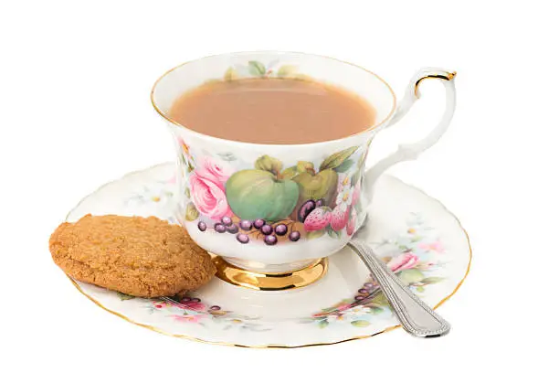 Photo of Cup of tea with a cookie biscuit