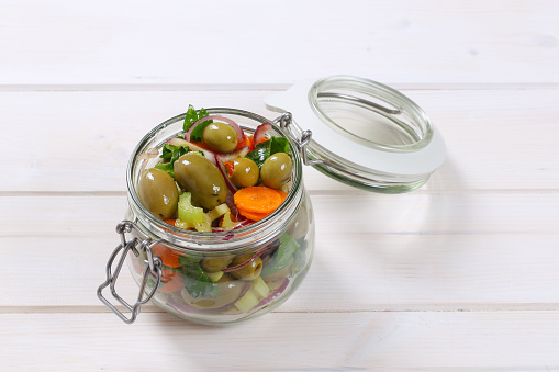Jar of Sicilian olive salad with carrot, celery and onion