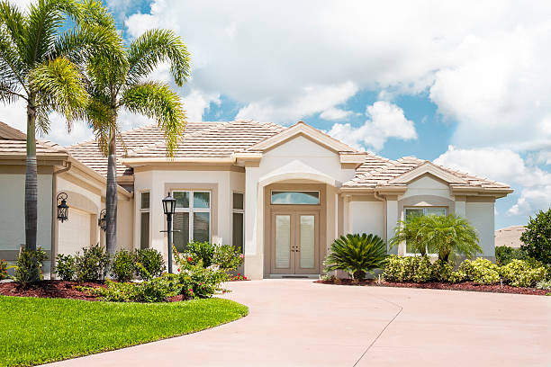 Beautiful New Home in the Tropics "Beautiful new home in the tropics; palm trees, tropical foliage, wide driveway." florida stock pictures, royalty-free photos & images
