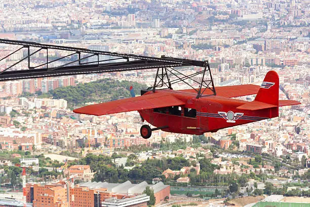 The airplane at the Tibidabo amusement park is making a circle around with overseeng a nice view of the city - Barcelona.
