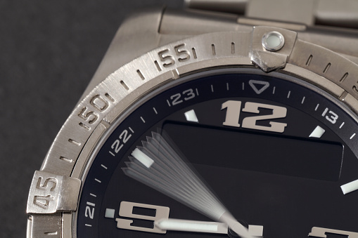 Detail macro of a water resistant wrist watch, minute hand is on the move