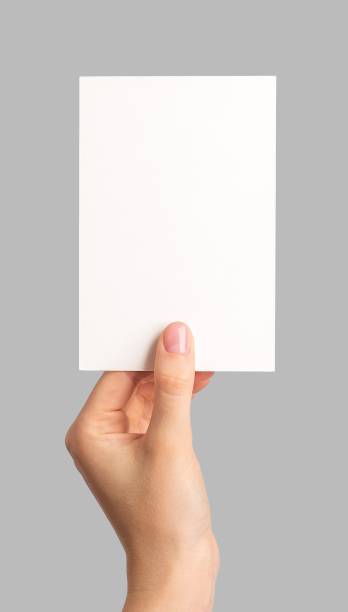 istock Blank paper card in hand. Holding postcard mockup isolated 1749318174