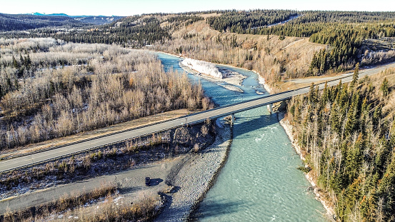 A drone flight over the frosty landscape of Interior Alaska is evidence that colder temperatures have arrived.  The Klutina River, once full of spawning salmon, is now entering a time of rest. Soon ice will form on the river as well. On this cold day in fall the river forges on despite the frigid temperatures. The bridge deck allows crossing over the river with ease for all who travel the Richardson highway.