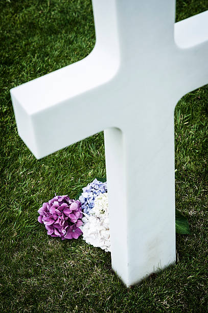 istock Flower near white cross in a cemetery 174932026