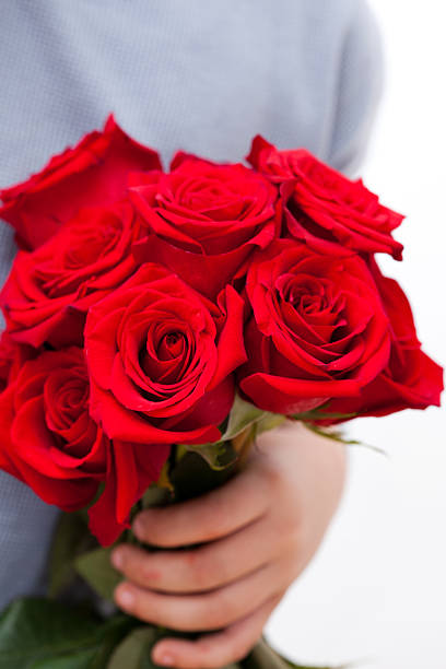 istock Child with a bouquet of red roses 174932065